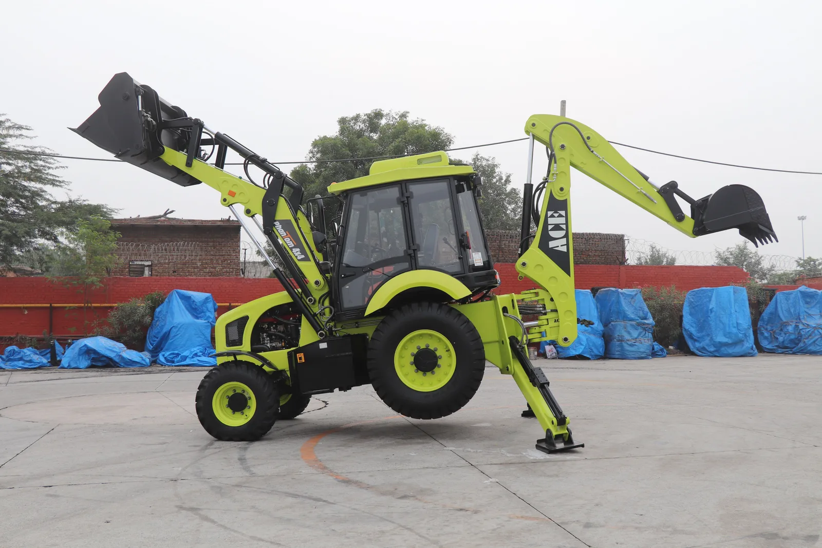 ACE Phantom backhoe loader displayed outdoors in Faridabad, India. Fence contractor equipment brands compared in 2027